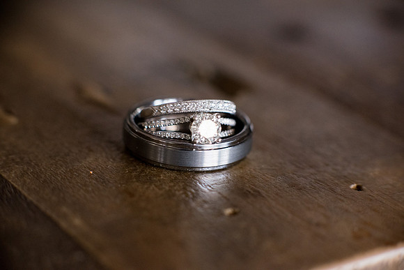 Wedding bands and engagement ring on wood table